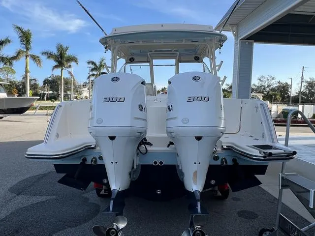 Slide: The Image of 2019 Grady-White Freedom 325 boat with twin Yamaha 300 engines, docked outdoors. - 6