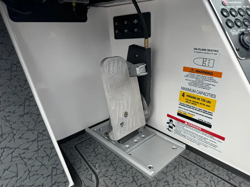 Slide: The Image of Foot pedal and capacity warning in 2025 Vexus VXS21 boat interior. - 16