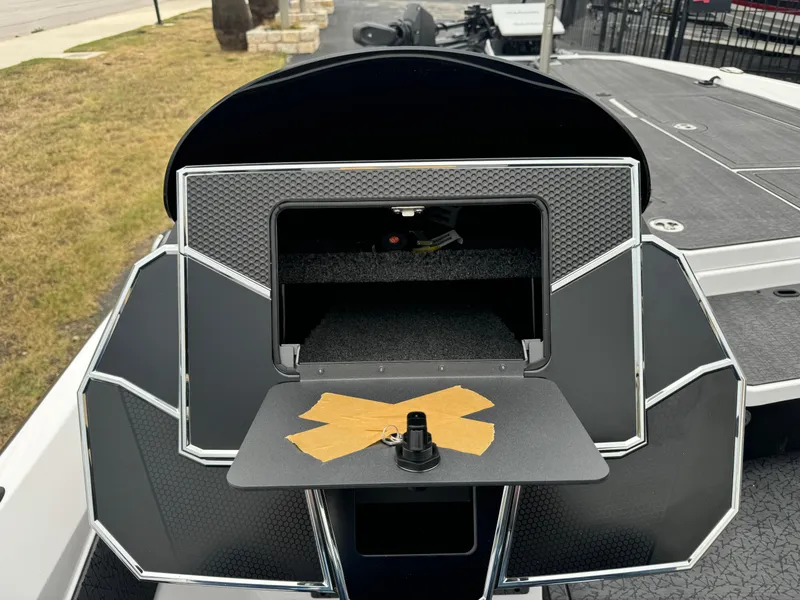 Slide: The Image of 2025 Vexus VXS21 boat dashboard with storage compartment and taped surface. - 24