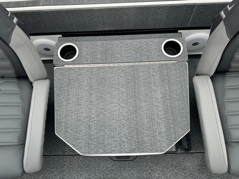 Slide: The Image of 2025 Vexus VXS21 boat interior with gray seating and table featuring cup holders. - 25