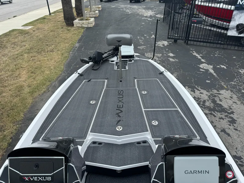 Slide: The Image of 2025 Vexus VXS21 boat deck with Garmin electronics, parked on a paved area. - 27