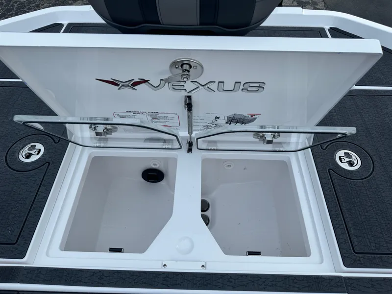 Slide: The Image of 2025 Vexus VXS21 boat storage compartment with open lid and logo. - 42