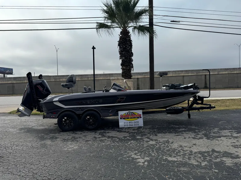 Slide: The Image of 2025 Vexus VXS21 boat on trailer, parked outdoors near palm tree. - 48