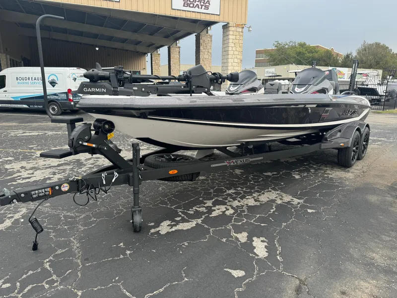 Slide: The Image of 2025 Vexus VXS21 boat on trailer, parked outside dealership. - 6