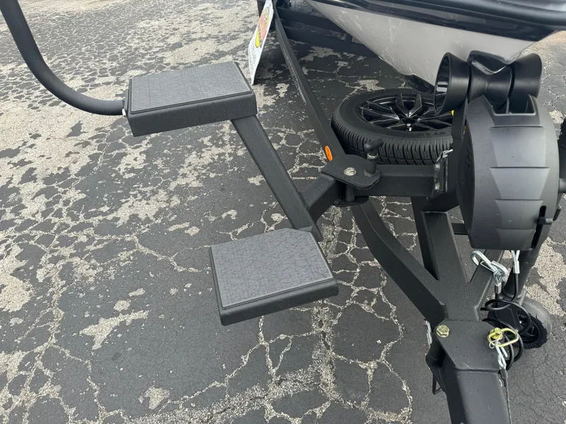Slide: The Image of 2025 Vexus VXS21 boat trailer with dual steps and spare tire on asphalt. - 8
