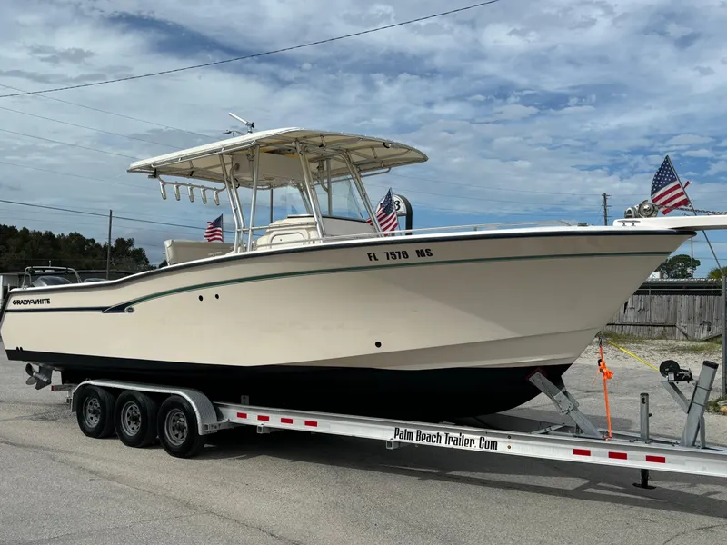 Slide: The Image of 2005 Grady-White Bimini 306 boat on trailer with American flags. - 10