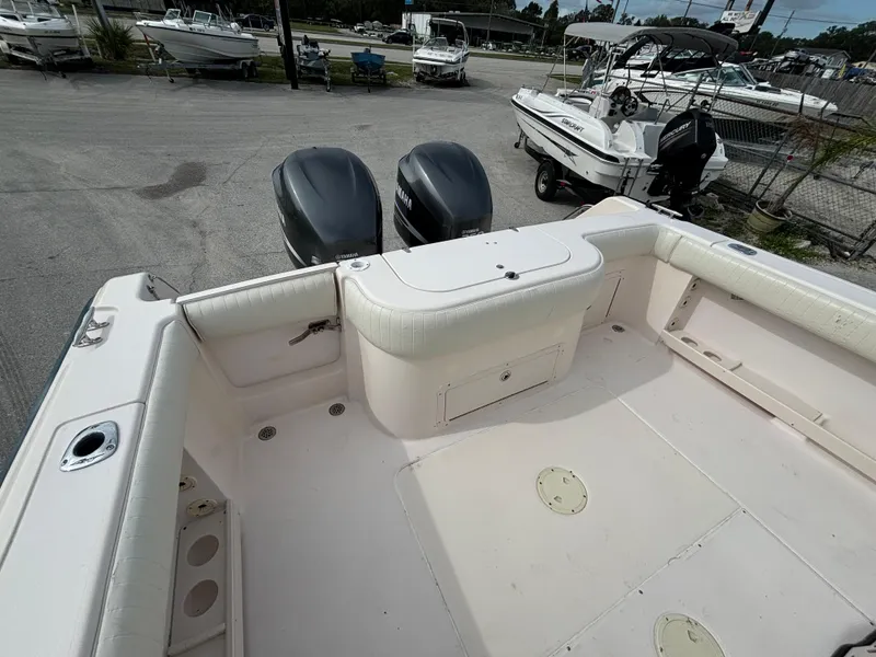 Slide: The Image of 2005 Grady-White Bimini 306 boat with dual engines, spacious deck, and storage compartments. - 19