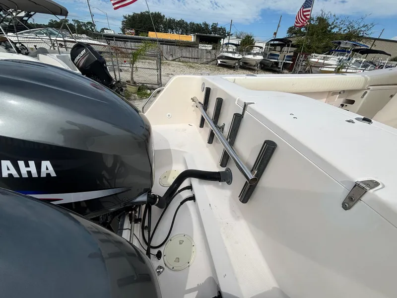 Slide: The Image of 2005 Grady-White Bimini 306 boat with Yamaha engines, docked with American flags in background. - 21