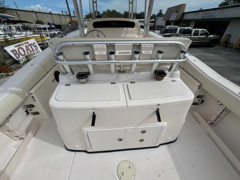 Slide: The Image of 2005 Grady-White Bimini 306 boat interior with rod holders and storage compartments. - 23
