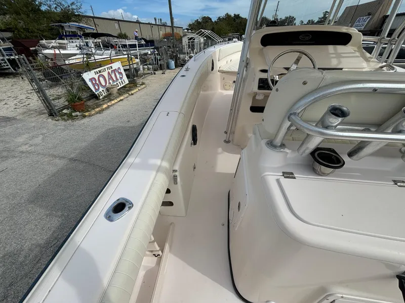 Slide: The Image of 2005 Grady-White Bimini 306 boat interior with steering console and seating area. - 25
