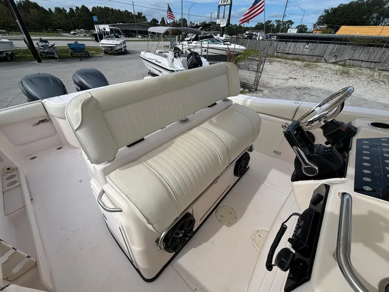 Slide: The Image of 2005 Grady-White Bimini 306 boat interior with white seating and steering console. - 29