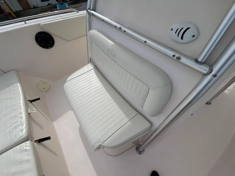 Slide: The Image of 2005 Grady-White Bimini 306 boat interior with white cushioned seating. - 38