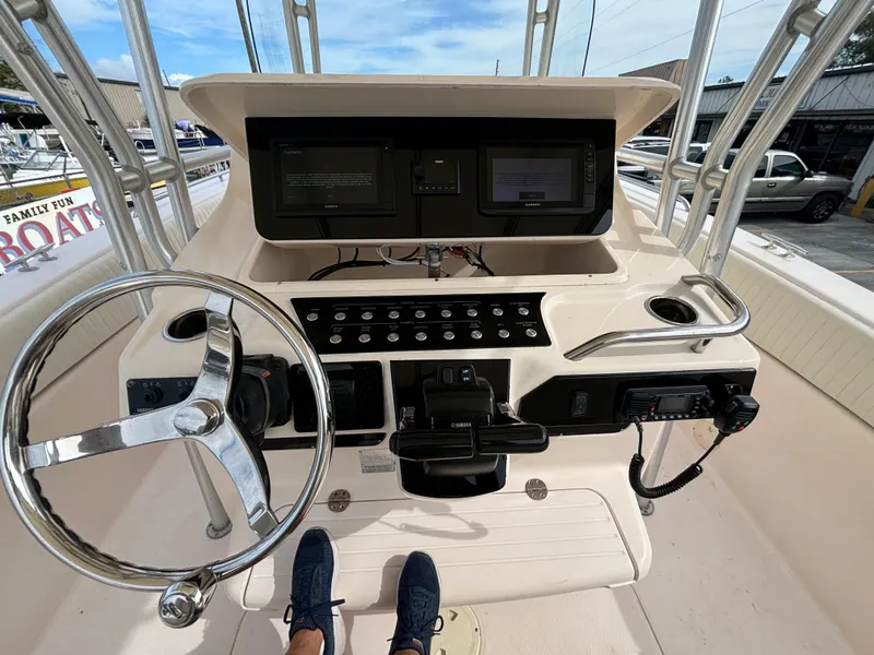 Slide: The Image of 2005 Grady-White Bimini 306 boat console with steering wheel and navigation controls. - 44