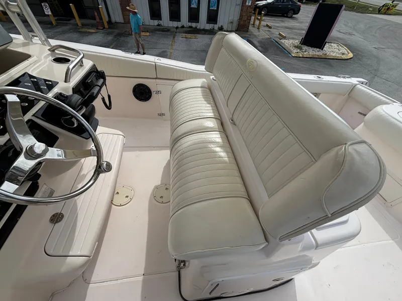 Slide: The Image of 2005 Grady-White Bimini 306 boat interior with white leather seating and steering wheel. - 46