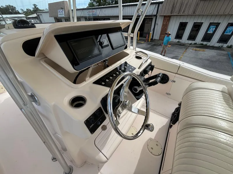 Slide: The Image of 2005 Grady-White Bimini 306 boat helm with steering wheel and controls. - 47