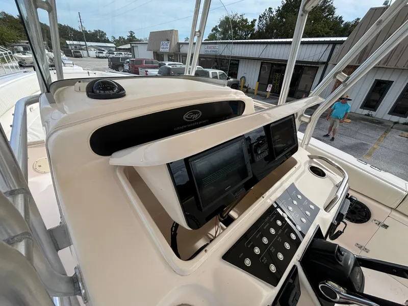 Slide: The Image of 2005 Grady-White Bimini 306 boat dashboard with navigation controls. - 48