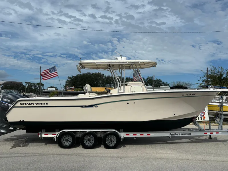 Slide: The Image of 2005 Grady-White Bimini 306 boat on trailer with American flag in background. - 9
