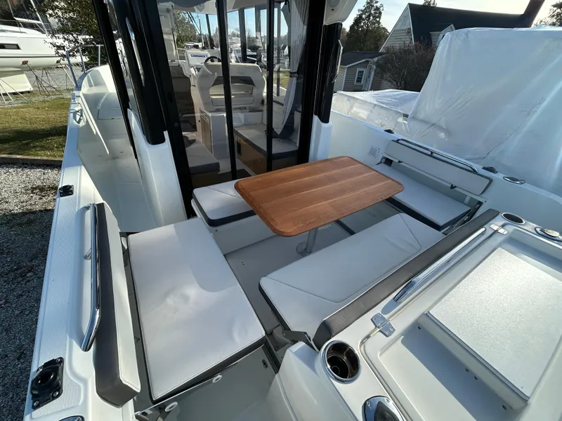 Slide: The Image of 2020 Beneteau Barracuda boat interior with seating and wooden table. - 10