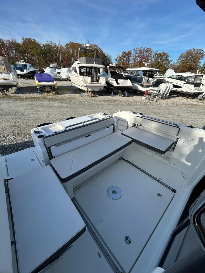 Slide: The Image of 2020 Beneteau Barracuda boat interior with seating, docked among other boats. - 13