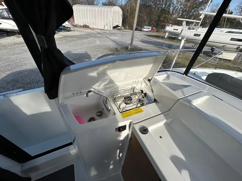 Slide: The Image of 2020 Beneteau Barracuda boat interior with open storage compartment and sink. - 14