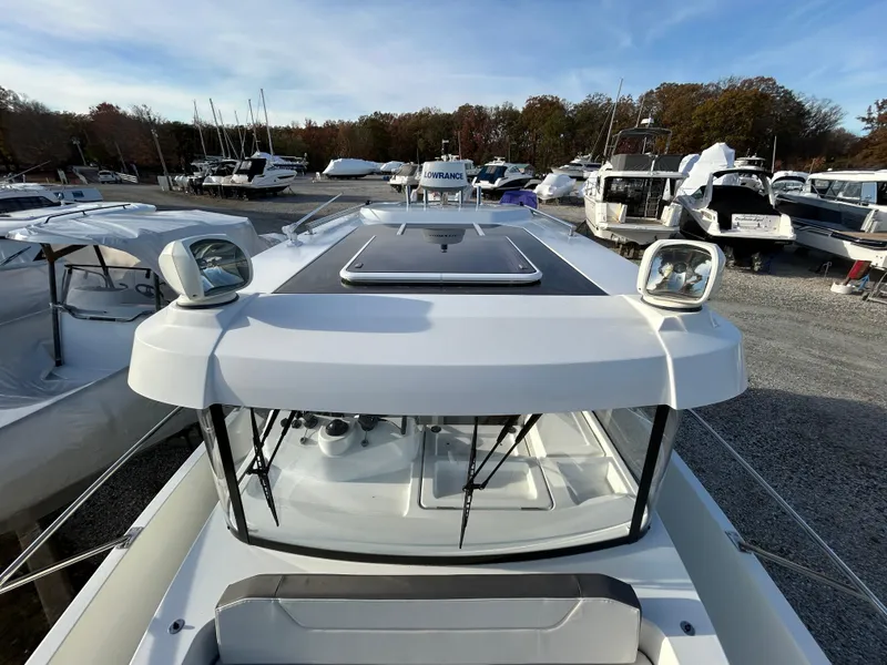 Slide: The Image of 2020 Beneteau Barracuda boat docked, surrounded by other vessels under a clear sky. - 2