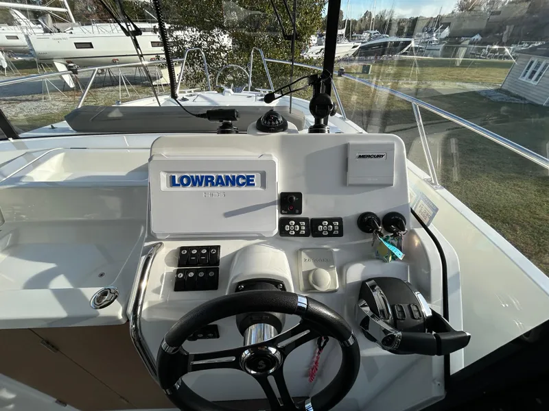 Slide: The Image of 2020 Beneteau Barracuda boat dashboard with Lowrance and Mercury controls. - 7
