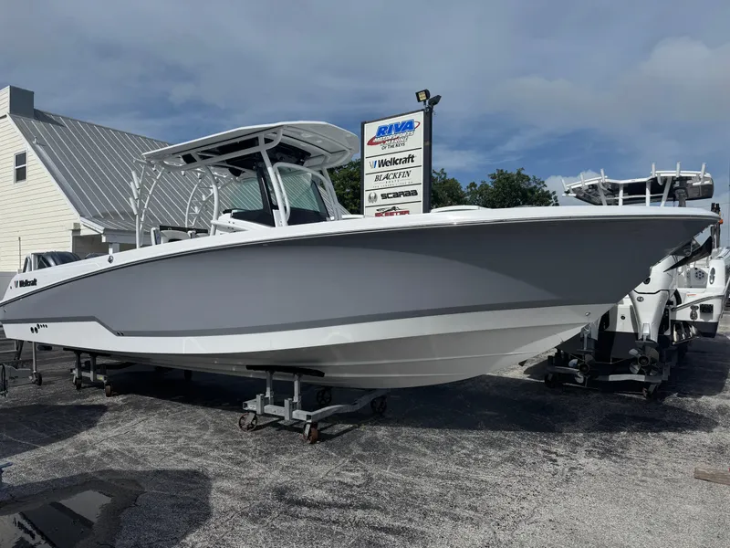 The Image of 2025 Wellcraft 302 Fisherman boat displayed outdoors on a stand. - 1