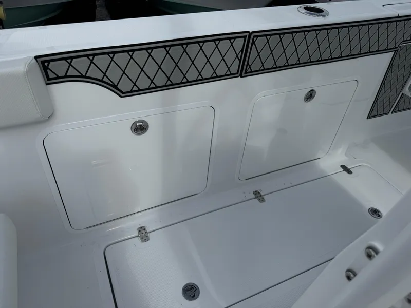 Slide: The Image of 2025 Wellcraft 302 Fisherman boat interior with storage compartments and sleek design. - 11