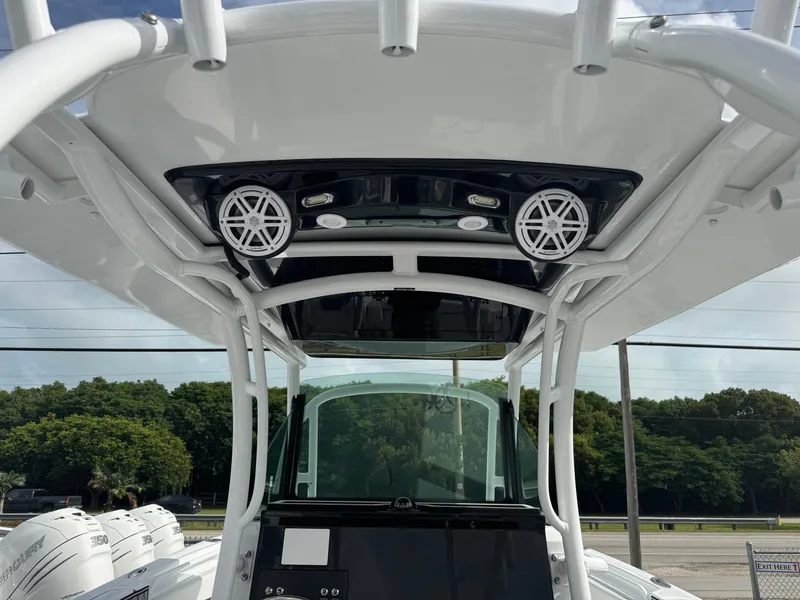 Slide: The Image of 2025 Wellcraft 302 Fisherman boat with T-top and speakers, showcasing modern design. - 14