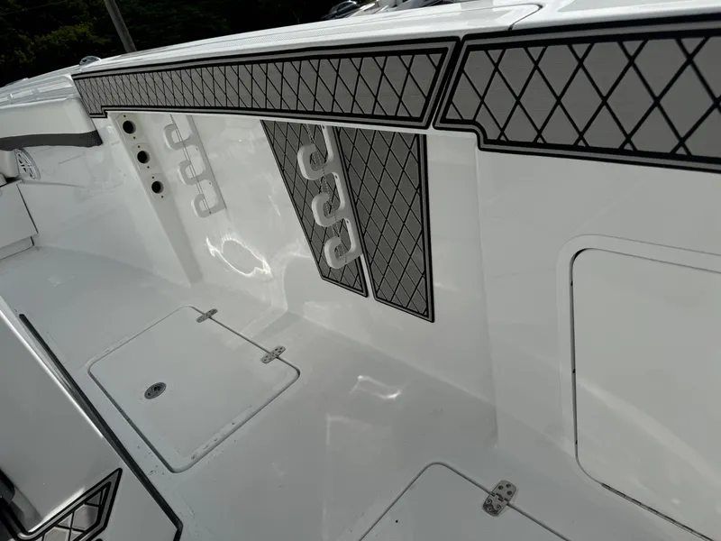 Slide: The Image of 2025 Wellcraft 302 Fisherman boat interior with sleek white design and diamond-patterned accents. - 16