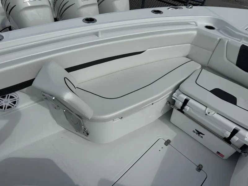 Slide: The Image of 2025 Wellcraft 302 Fisherman boat interior with white seating and storage. - 21