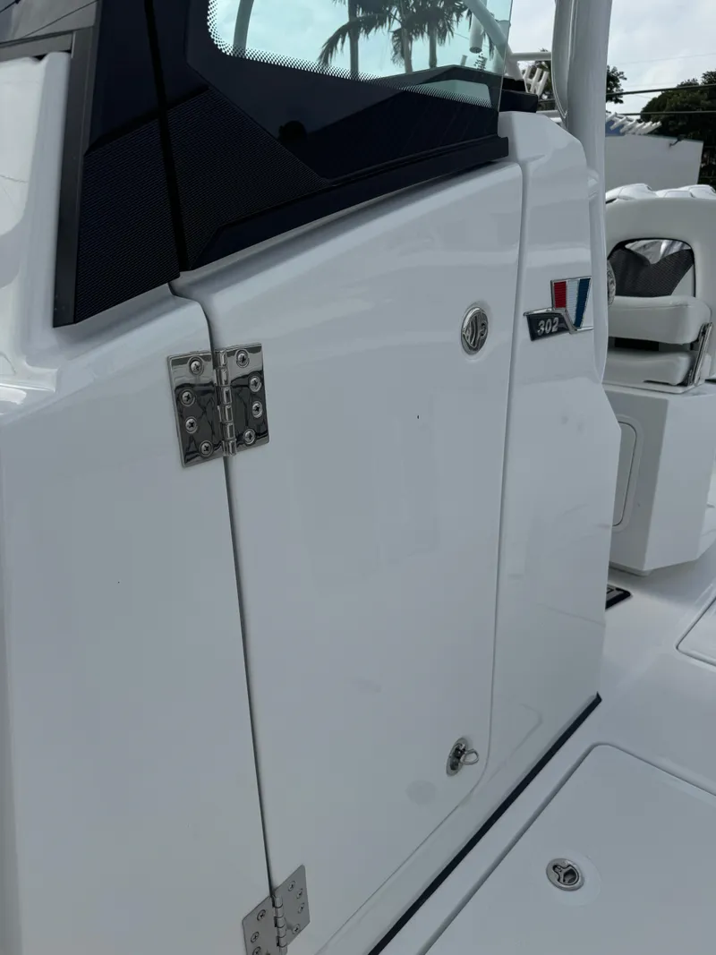 Slide: The Image of 2025 Wellcraft 302 Fisherman boat, sleek white exterior, close-up view. - 27