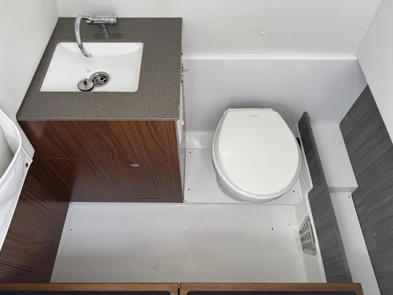 Slide: The Image of 2025 Wellcraft 302 Fisherman boat bathroom with sink and toilet. - 29