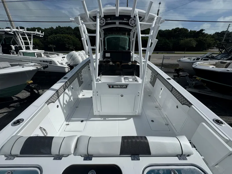 Slide: The Image of 2025 Wellcraft 302 Fisherman boat interior with center console and seating. - 3