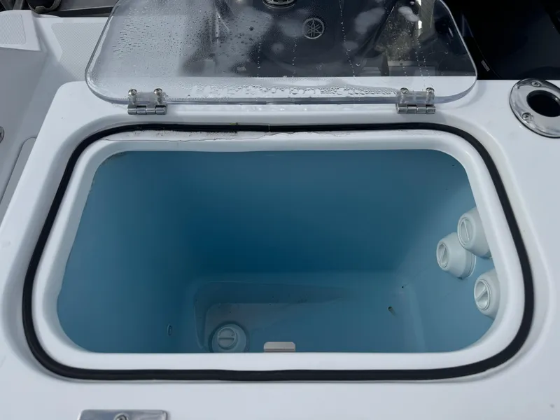 Slide: The Image of 2025 Wellcraft 302 Fisherman boat livewell with open lid, showcasing interior space. - 9
