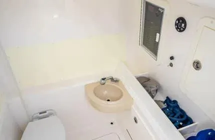 Slide: The Image of 2019 Invincible 36 Open Fisherman boat interior with sink and storage. - 10