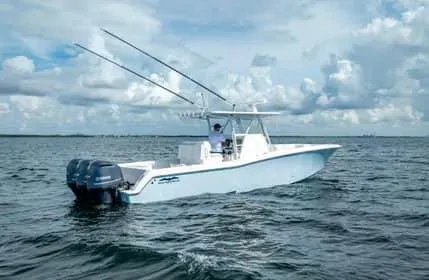Slide: The Image of 2019 Invincible 36 Open Fisherman boat on open water under cloudy sky. - 15