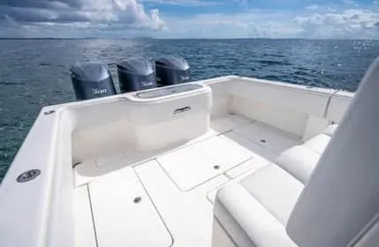 Slide: The Image of 2019 Invincible 36 Open Fisherman boat on open water, featuring triple engines. - 17