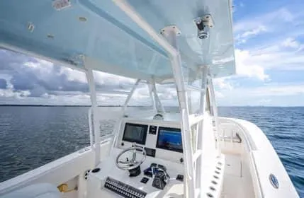 Slide: The Image of 2019 Invincible 36 Open Fisherman boat on open sea, featuring modern helm and controls. - 19
