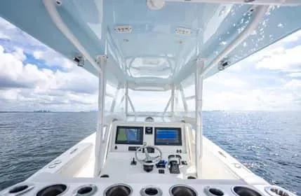 Slide: The Image of Invincible 36 Open Fisherman 2019 boat console with dual screens on open water. - 21
