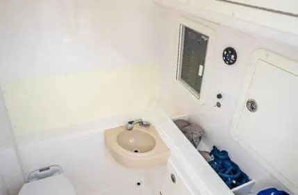 Slide: The Image of 2019 Invincible 36 Open Fisherman boat interior with sink and storage compartments. - 22