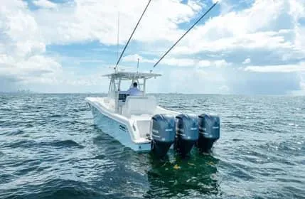 Slide: The Image of 2019 Invincible 36 Open Fisherman boat on open sea with triple engines. - 26