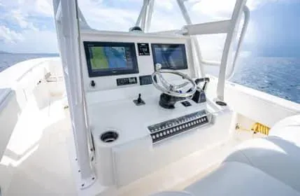 Slide: The Image of 2019 Invincible 36 Open Fisherman boat cockpit with dual screens and steering wheel. - 32