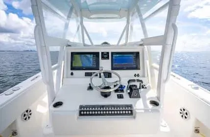 Slide: The Image of 2019 Invincible 36 Open Fisherman boat console with dual screens on open water. - 33