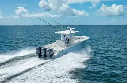 Slide: The Image of 2019 Invincible 36 Open Fisherman speeding on open water under blue skies. - 34