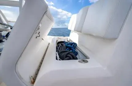 Slide: The Image of 2019 Invincible 36 Open Fisherman boat storage compartment with ropes, ocean view. - 41