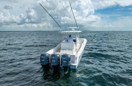 Slide: The Image of 2019 Invincible 36 Open Fisherman boat on open sea with triple engines. - 42