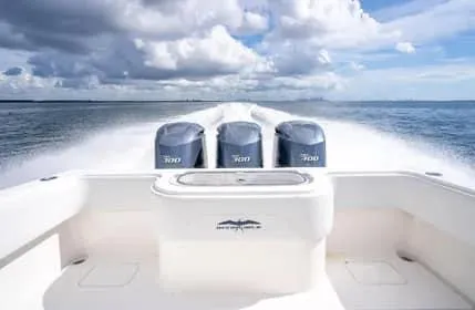 Slide: The Image of 2019 Invincible 36 Open Fisherman boat with triple engines on open water. - 45