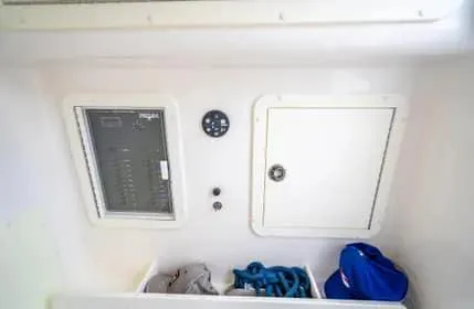 Slide: The Image of 2019 Invincible 36 Open Fisherman storage compartment with control panel and gear. - 49