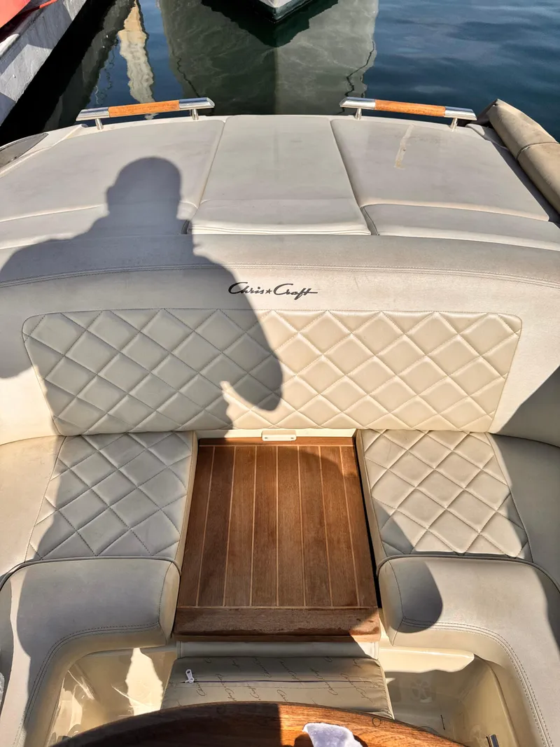 Slide: The Image of 2014 Chris-Craft Launch 25 boat interior with quilted seats and wooden accents. - 11